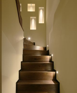 Stairs lit with floorwashers and niches lit by John Cullen Lighting
