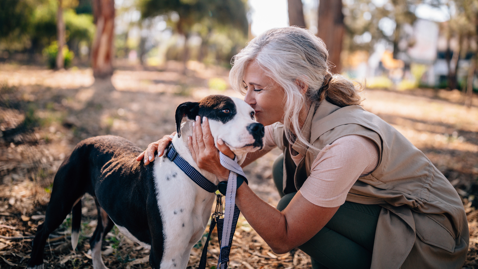 Lady kissing her dog