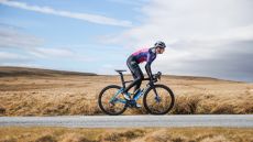 Image of female cyclist riding on a cold but sunny day