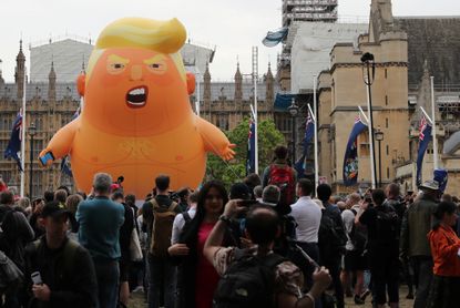 A "Baby Tump" balloon flies over London.