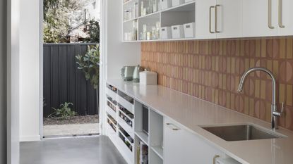 Modern clean kitchen with terracotta backsplash