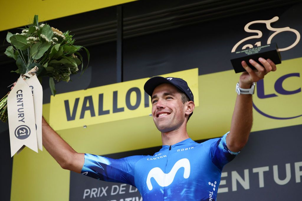 Movistar Team's Basque rider Oier Lazkano celebrates on the podium with the most combative rider's award after the 4th stage of the 111th edition of the Tour de France cycling race, 140 km between Pinerolo in Italy, and Valloire in France, on July 2, 2024. (Photo by Anne-Christine POUJOULAT / AFP)