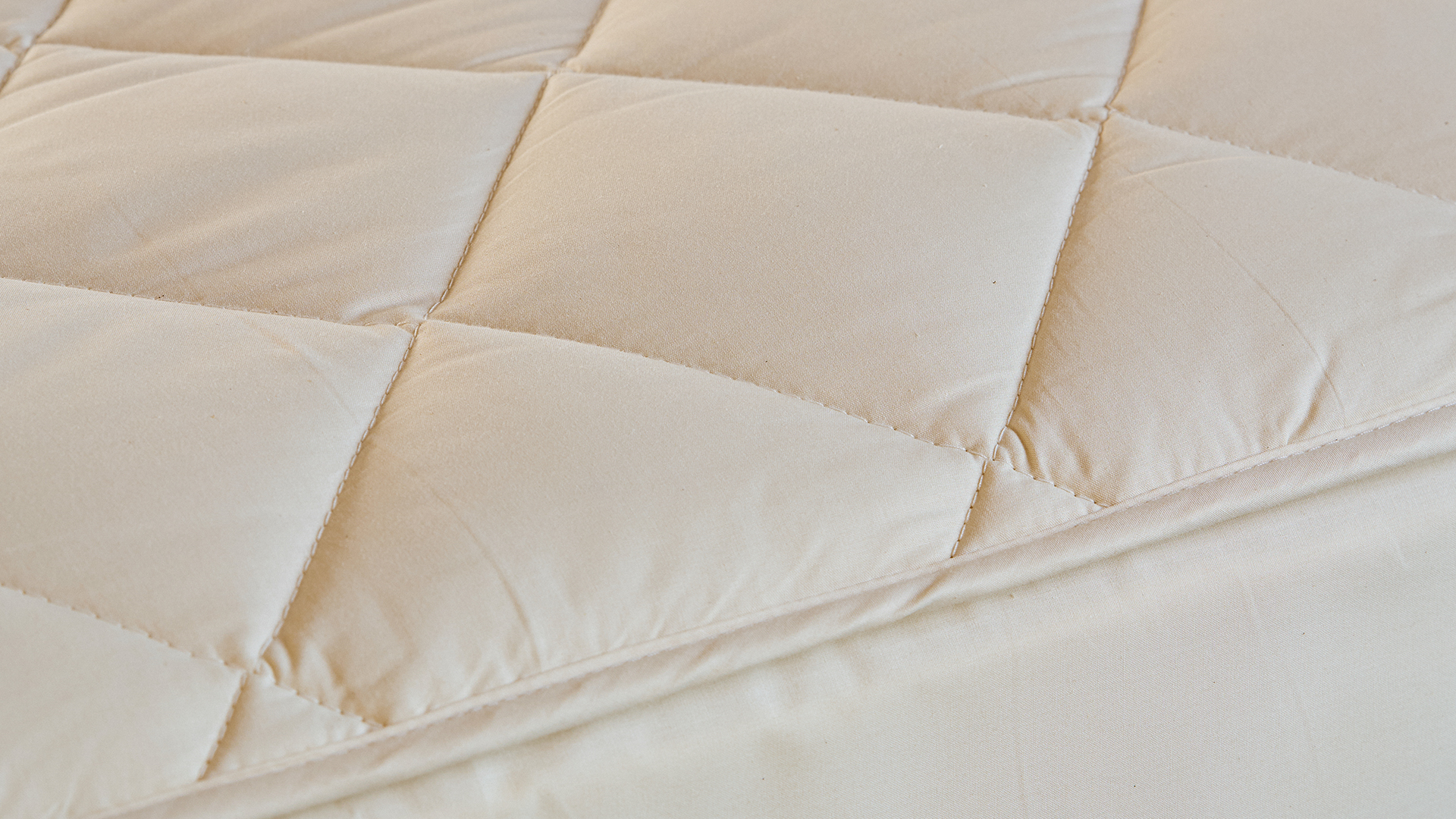 Close up of the quilted consistency of the Woolroom deluxe mattress protector