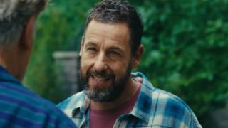 Adam Sandler stands with an evil smile in front of Christopher McDonald in Happy Gilmore 2.