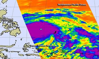 Infrared data from the AIRS instrument aboard NASA's Aqua satellite show cloud top temperatures as cold as 210 degrees kelvin/-81.67F/-63.15C/ in the thick band of thunderstorms around the center of Super Typhoon Haiyan on Nov. 7, 2013. Those cold temperatures indicate very high, powerful thunderstorms with very heavy rain potential.