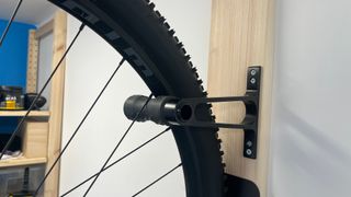 Close up of wheel in Lezyne CNC Alloy Wheel Hook on wall