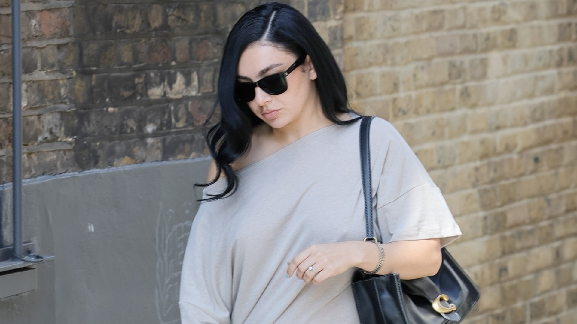 Charli xcx styled an indie-sleaze shirt dress with platform pumps and an oversized Coach Tabby Bag