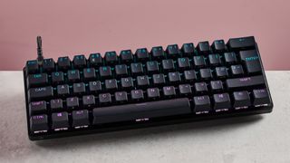 SteelSeries Apex Pro Mini on desk with pink background