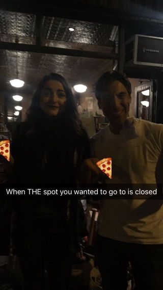 Charlotte Palermino and Mark Iacono outside pizza parlour at night
