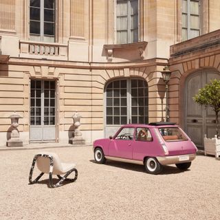 Pink Renault, pictured beside a chair
