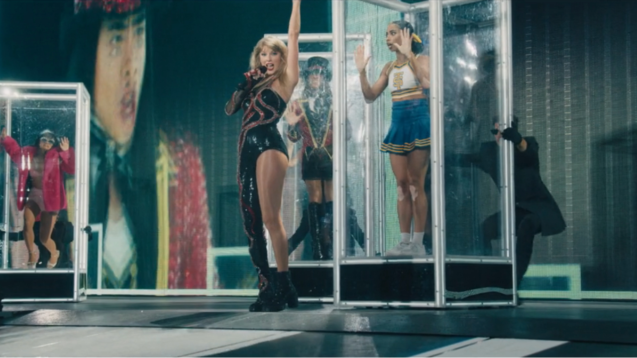 Taylor Swift in her Eras Tour Reputation bodysuit, next to dancer Taylor Banks dressed as 