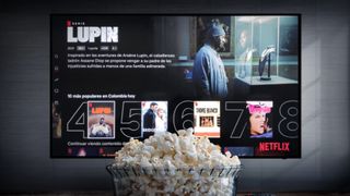 Bowl of popcorn in front of a TV showing Netflix