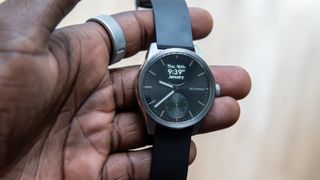 The Withings ScanWatch 2 in hand with the display on