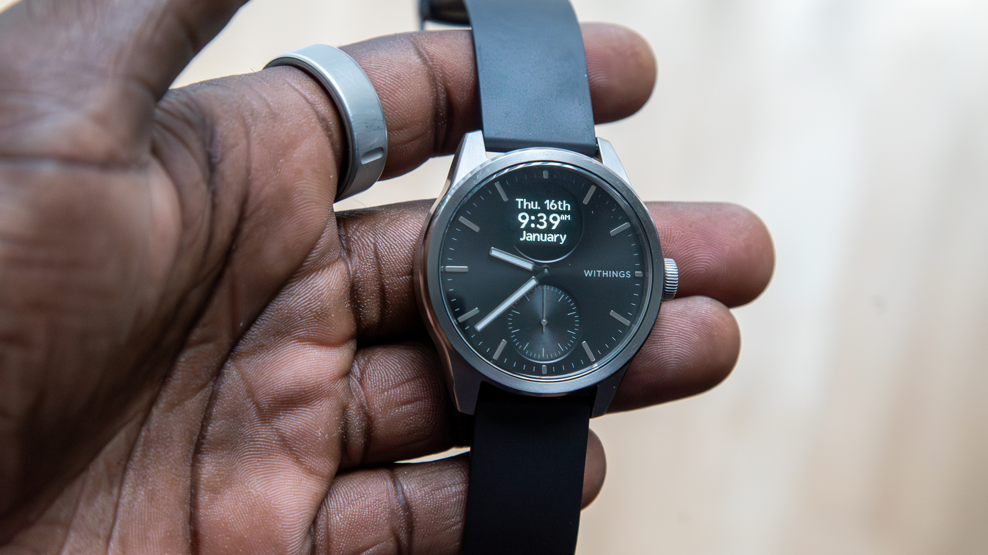 The Withings ScanWatch 2 in hand with the display on