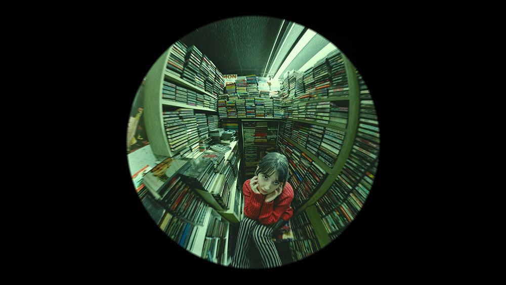 A render created in Blender showing a girl surrounded by cassettes 