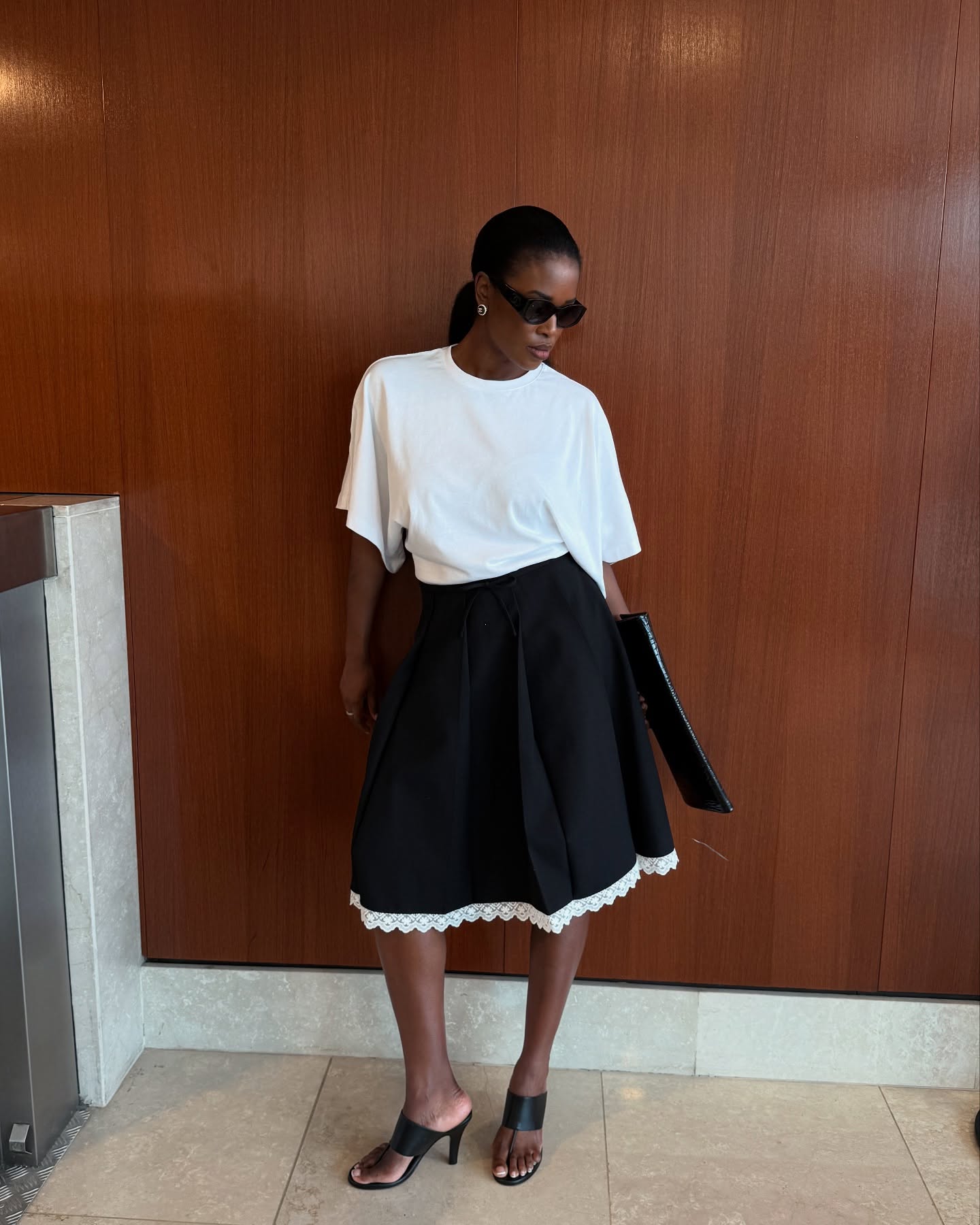 Marilyn wears an Oversized T-Shirt + Midi Skirt + Thong Sandals