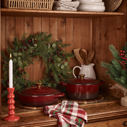George Home Cast Iron Collection in burgundy on a festive dresser.