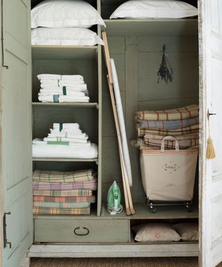 laundry cupboard with folded sheets