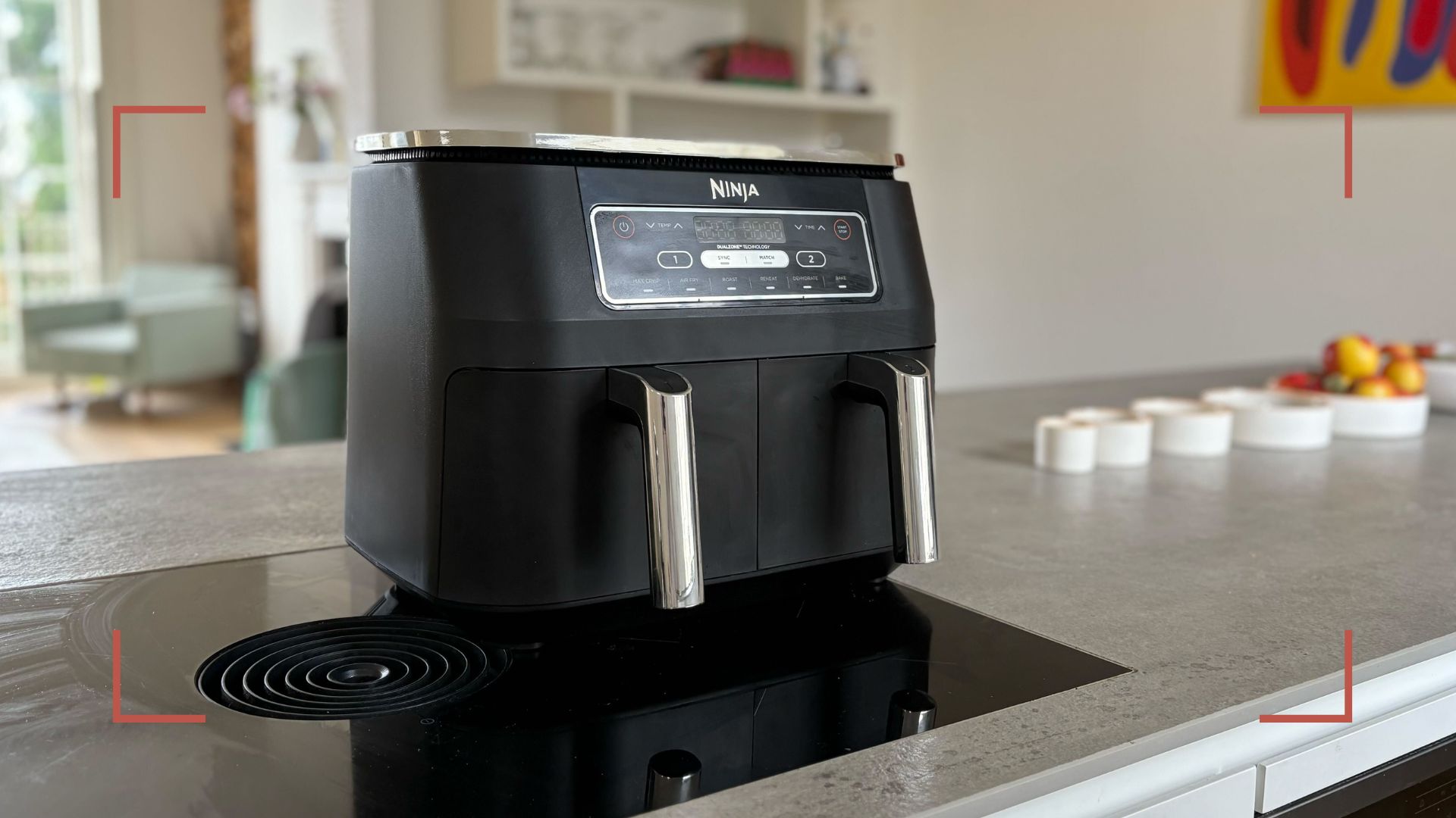 Black dual drawer Ninja air fryer on a kitchen counter induction hob to show the wort places to put an air fryer