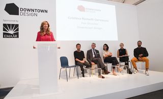 Downtown Design director Cristina Romelli Gervasoni introduces speakers at the fair