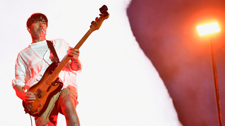 Alex James from Blur on stage at Coachella.