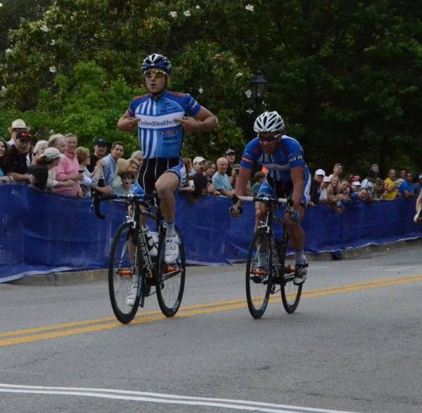 Race winner Jake Keough (UnitedHealthcare) pulls his hands off the bars as he rolls over the line.