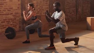 Man and woman perform split squat