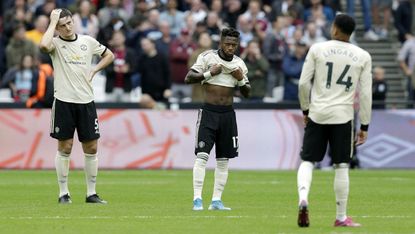 Manchester United players look dejected after West Ham scored their second goal at the London Stadium