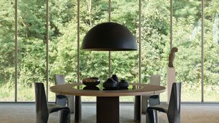 large black pendant light over round dining table