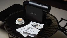 MORNING coffee machine on black coffee table with litetrally and prepared cup of coffee