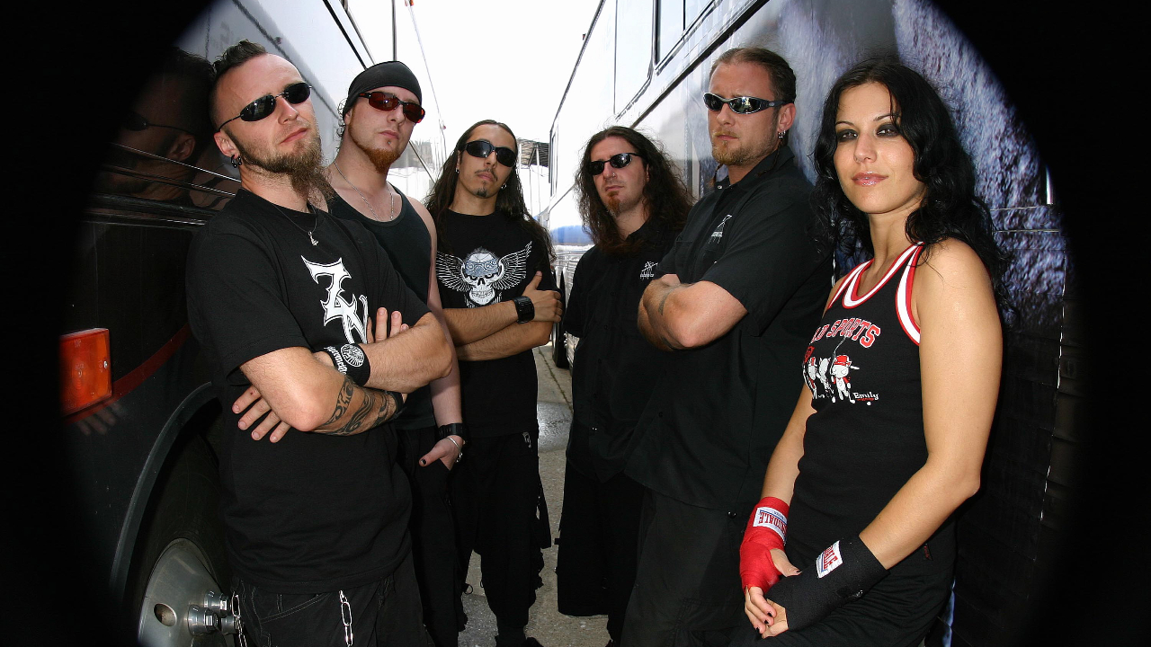 Lacuna Coil posing between two tourbuses in 2004