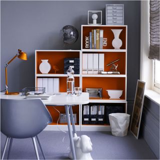 grey room orange and white cabinet with white table and white window