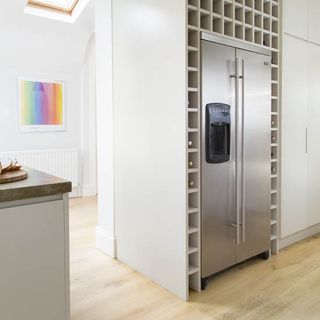 kitchen room with wooden flooring and integrated fridge