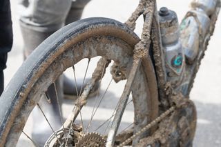 A rear zipp wheel with mud all over it