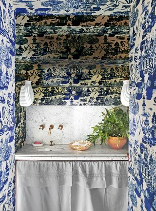 Powder room with blue and white wallpaper