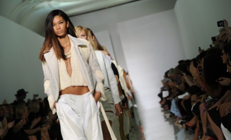 Models walk the runway Saturday sporting Kanye West's opulent if clumsy debut line, Dw, during Paris fashion week.