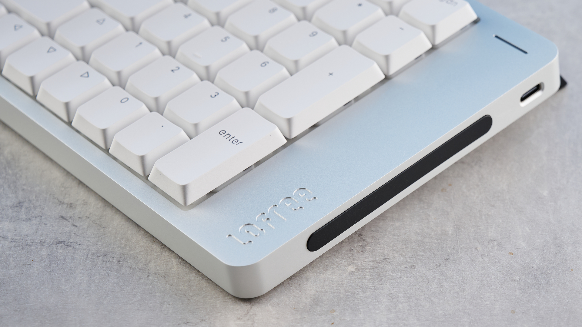 The Lofree Flow 2 on a stone surface with a blue background