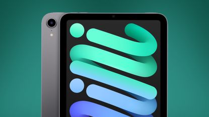 The iPad mini 6 tablet on a green background