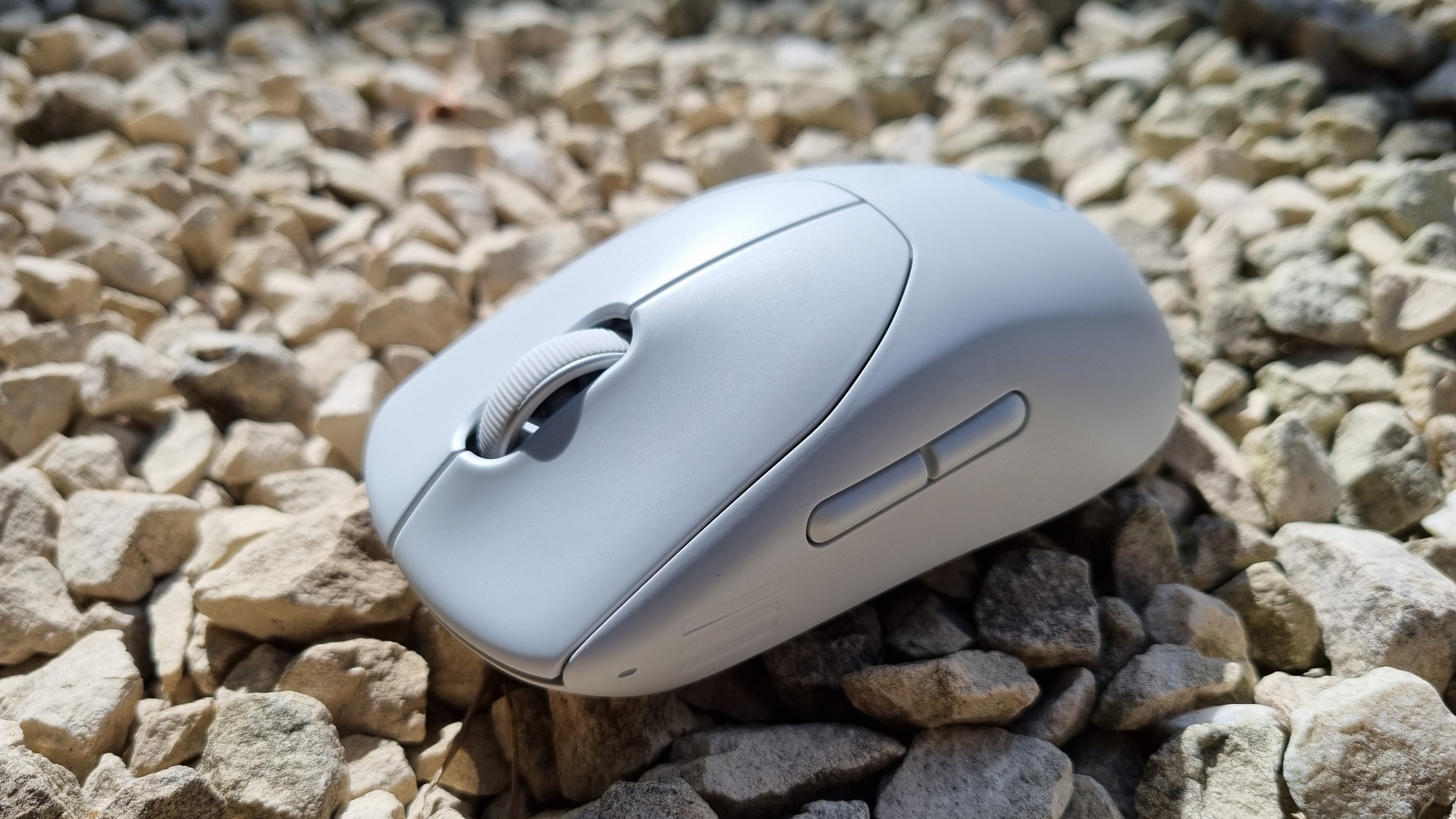 The Alienware Pro Wireless Gaming Mouse on white gravel