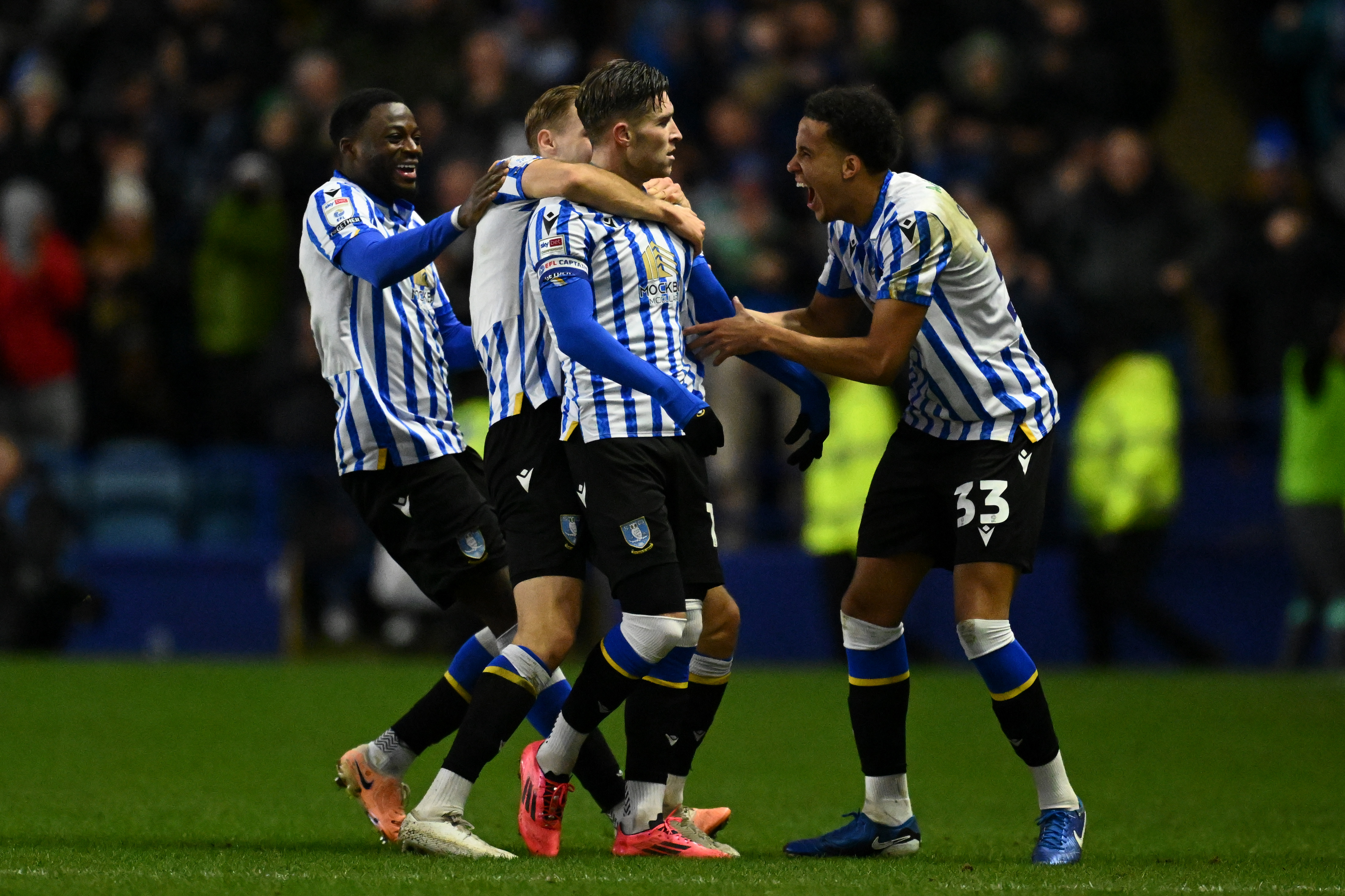 Josh Windass celebrates with his teammates after scoring from his own half for Sheffield Wednesday against Derby County, 1 January 2025