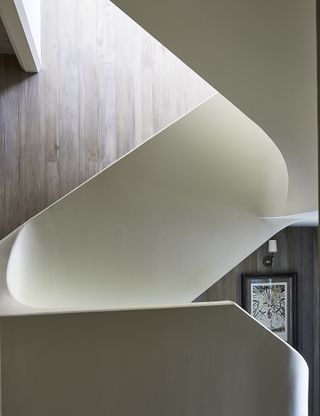 A staircase with curves plaster banisters
