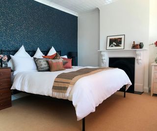double bedroom with feature wall using glittery wallpaper