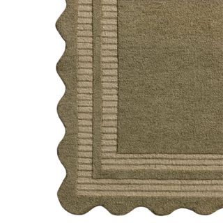 A pebbled wavy olive area rug