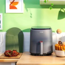 Image of Cosori Lite air fryer on countertop in promo image 