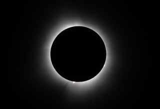 Thhe sun reaches totality during the eclipse on April 08, 2024 in Houlton, Maine. Millions of people have flocked to areas across North America that are in the 