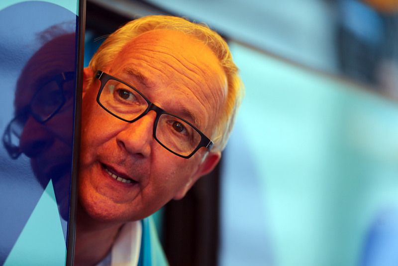 Astana DS Giuseppe Martinelli pops his head of the bus