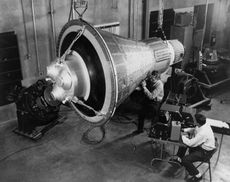 NASA engineers inspect a test Mercury capsule.