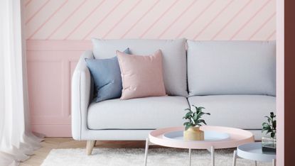 living room with grey sofa and pink striped wallpaper 