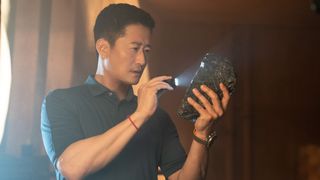 Jiuming (Wu Jing) inspecting a rock in The Meg 2: The Trench