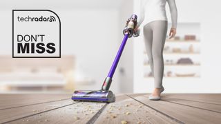 A woman using the Dyson V11 Advanced vacuum on a hardwood floor with a TechRadar deals logo